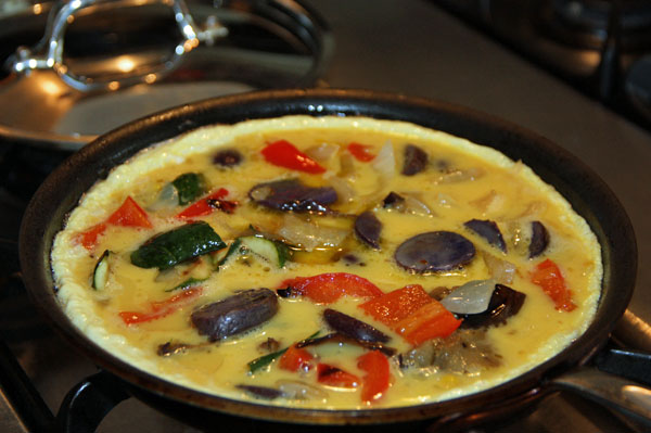 Fritatta cooking in a pan
