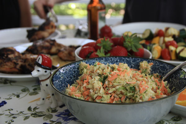 Homemade coleslaw on a table full of food