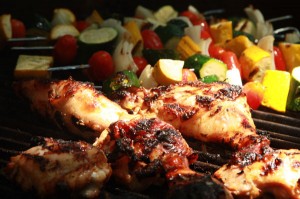 Jerk chicken and vegetable kabobs on a BBQ