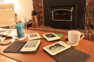 Four Kindles on a coffee table
