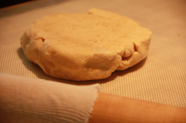 Pie crust dough on a pastry board