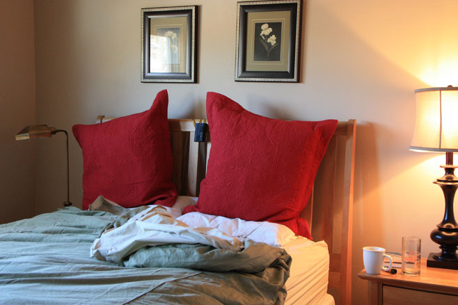 Bed with two big red pillows