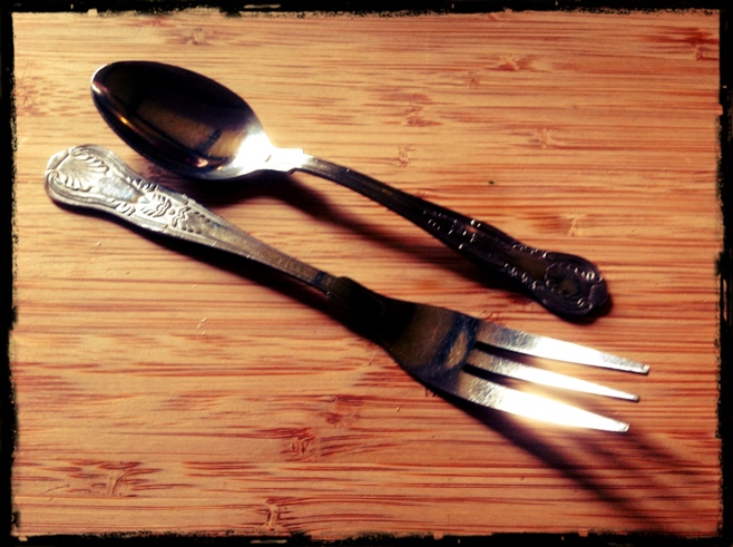 Fork and spoon on a board