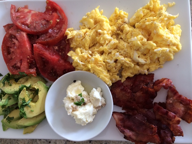 Tomato, eggs, bacon and avocado breakfast platter