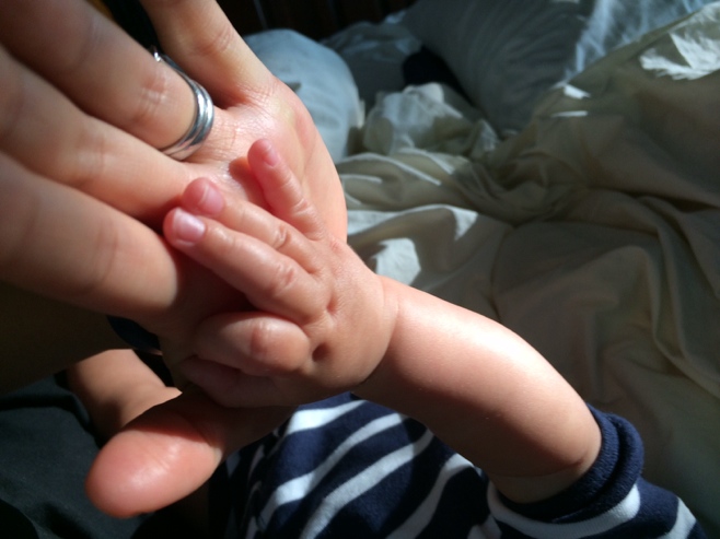 Mum and baby hands pressed together