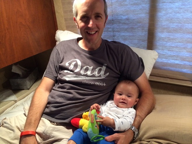 Dad and baby hanging out in bed