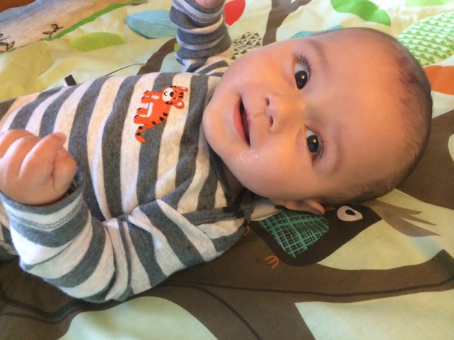 Baby smiling on activity mat