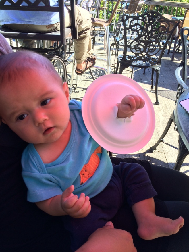 Baby with plate on his hand