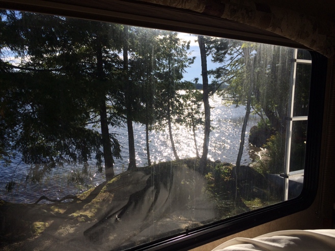 View of lake through dirty RV window
