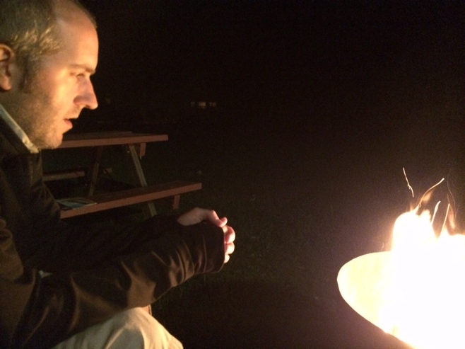 Man sitting by a campfire