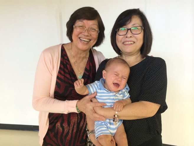 Grandma, Aunty and crying baby posing for photo