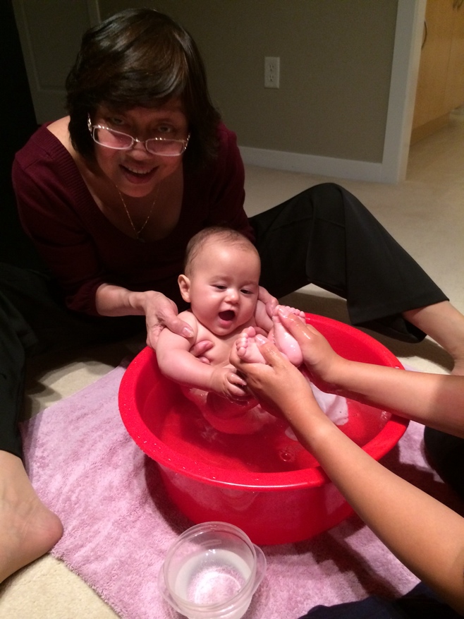 Grandma bathing baby