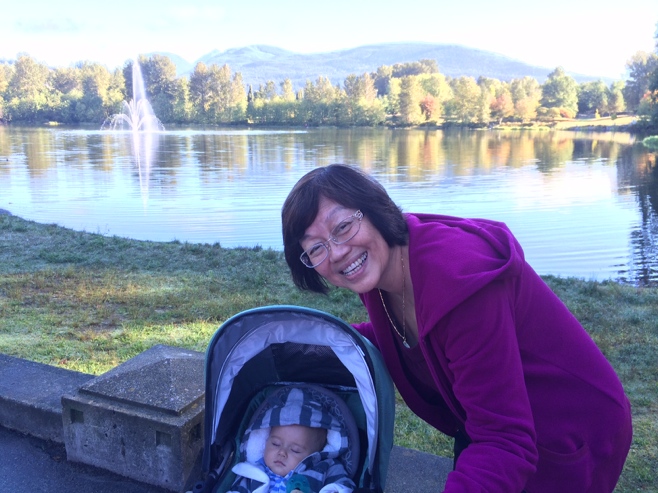 Grandma and sleeping baby in front of lake