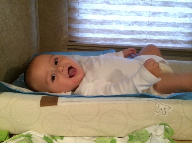 Happy baby having diaper change