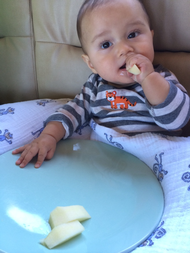 Baby with apple pieces