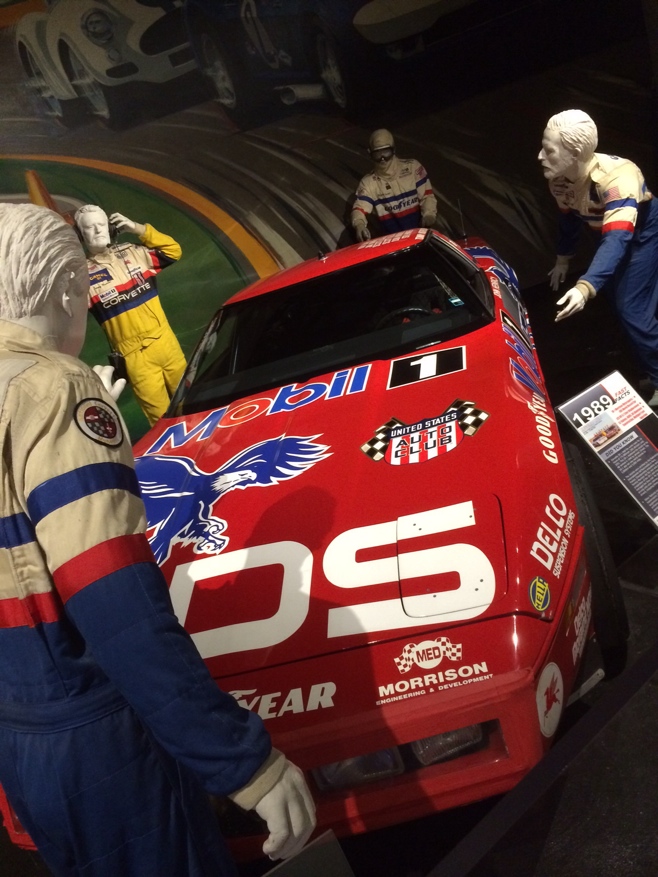 Racing corvette surrounded by mannequins