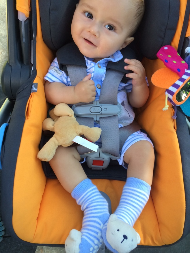 Baby in car seat smiling