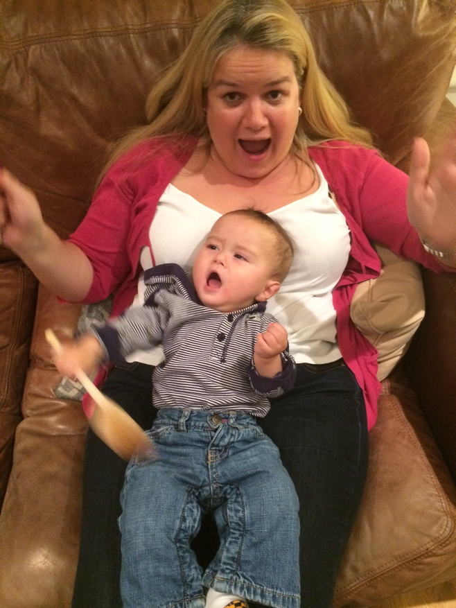 Woman and baby playing with wooden spoons