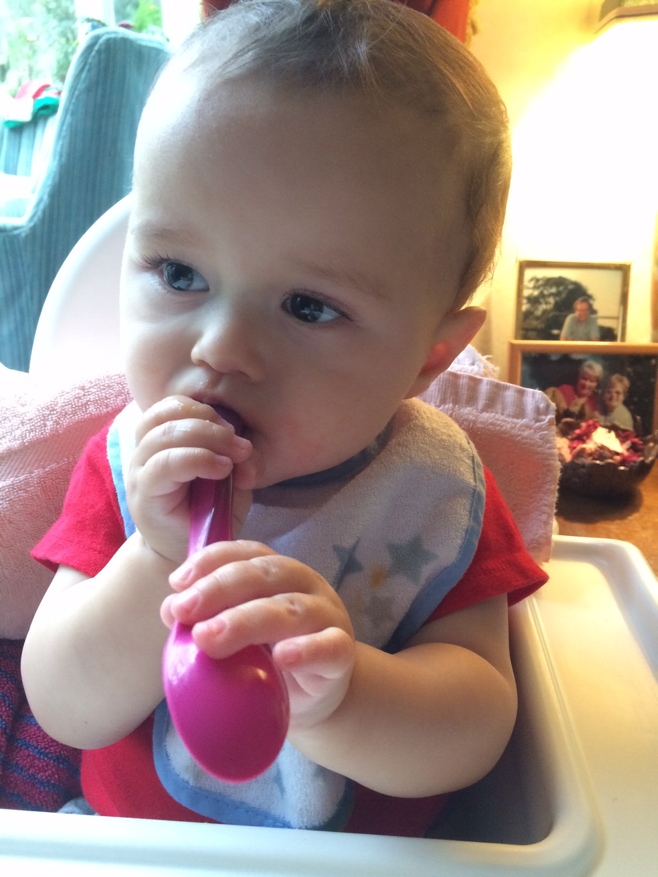 Baby with purple spoon