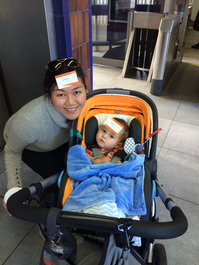 Mum and baby with train tickets stuck to forehead