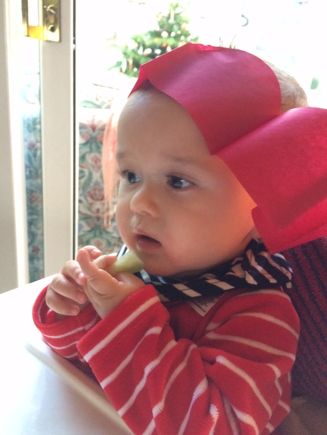 Baby wearing Christmas cracker hat