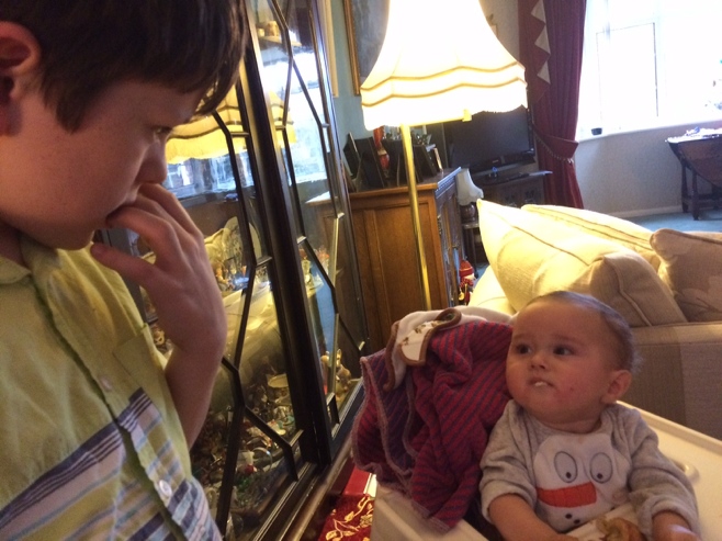 Boy and baby staring at each other