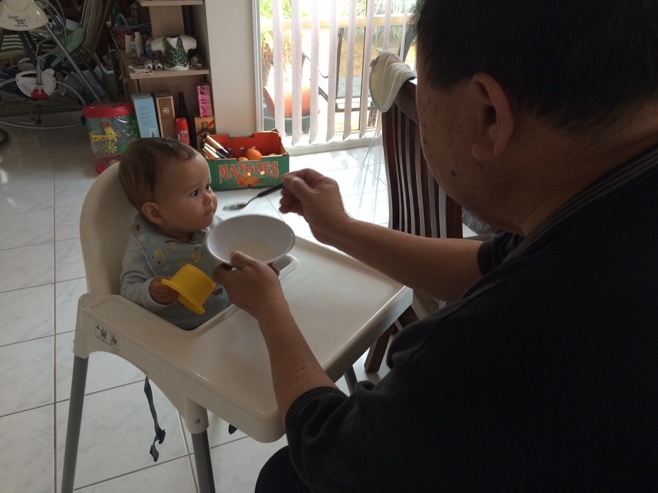Grandpa feeding baby