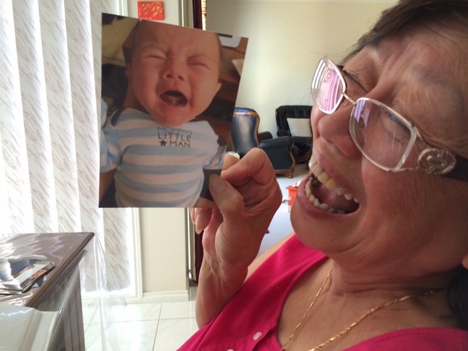 Grandma with photo of crying baby