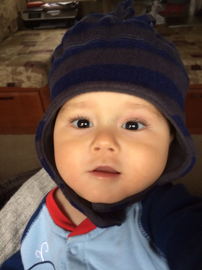 Baby smiling wearing winter hat