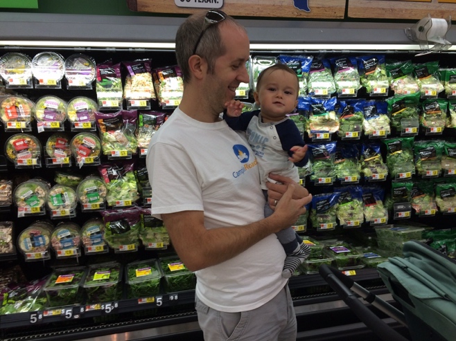 Dad holding baby in supermarket