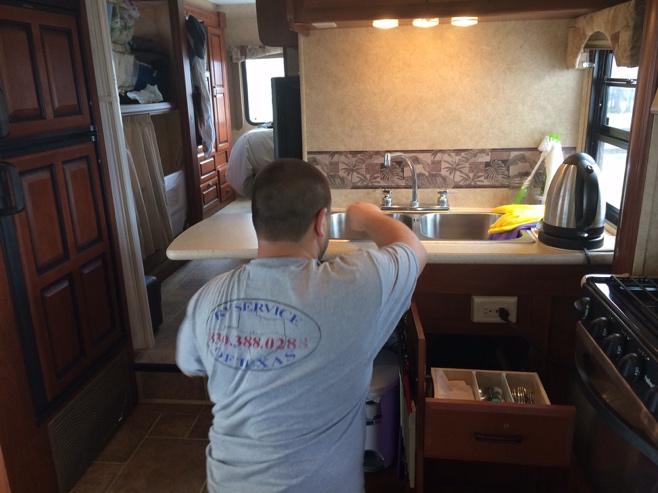 Man fixing the sink in the RV