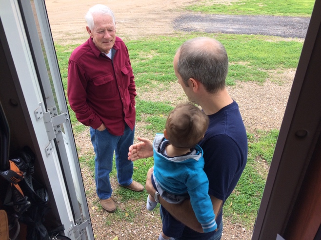 Two men and baby taking outside of RV