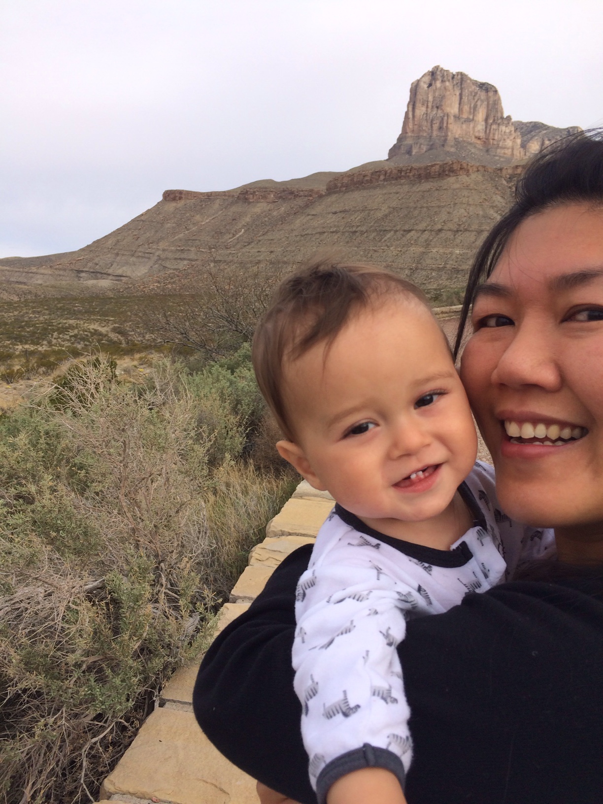 Mum cuddling baby boy o with Guadalupe peak in the background 