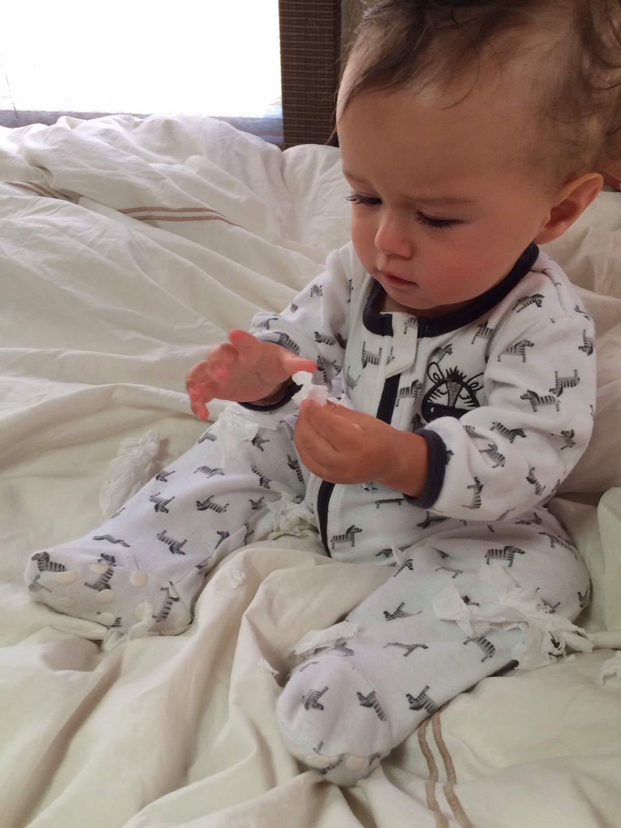 Baby boy o tearing tissue in bed